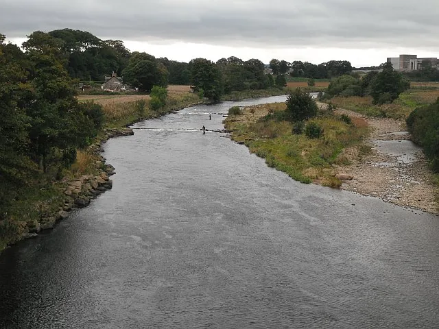 The River North Esk in Angus, Scotland, with anglers fishing from the Kincardineshire bank.