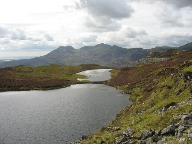 Upland lake (Llyn Dubach) in two connected basins, seen from above with the Moelwyn hills in the background, Snowdonia.