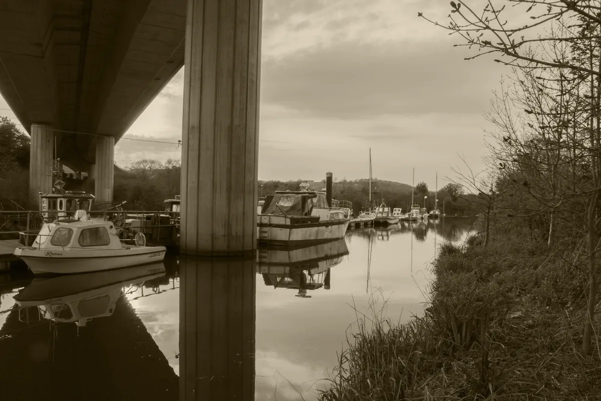 The River Ely flowing through green banks near Cardiff, Wales