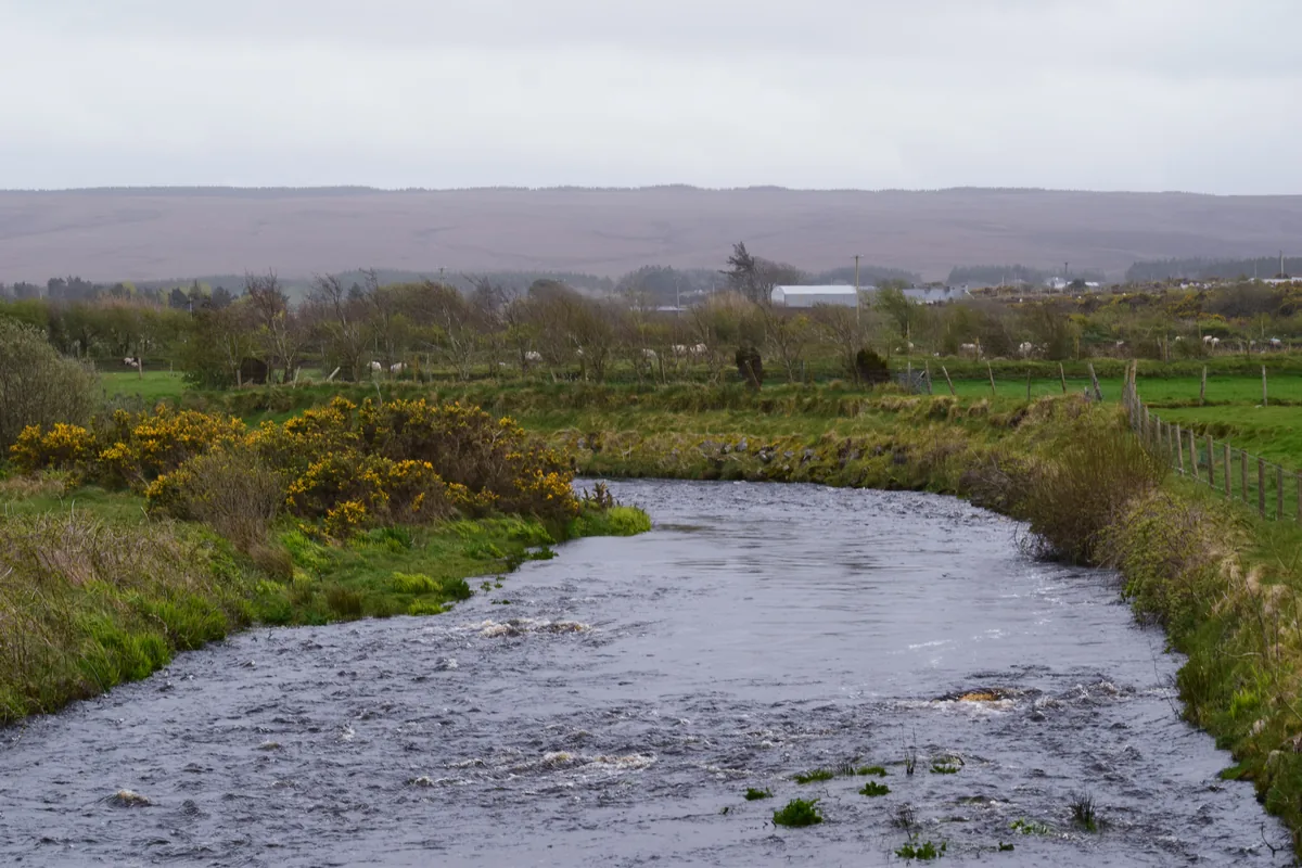 The Glenamoy River flowing through open bogland in north County Mayo, Ireland.