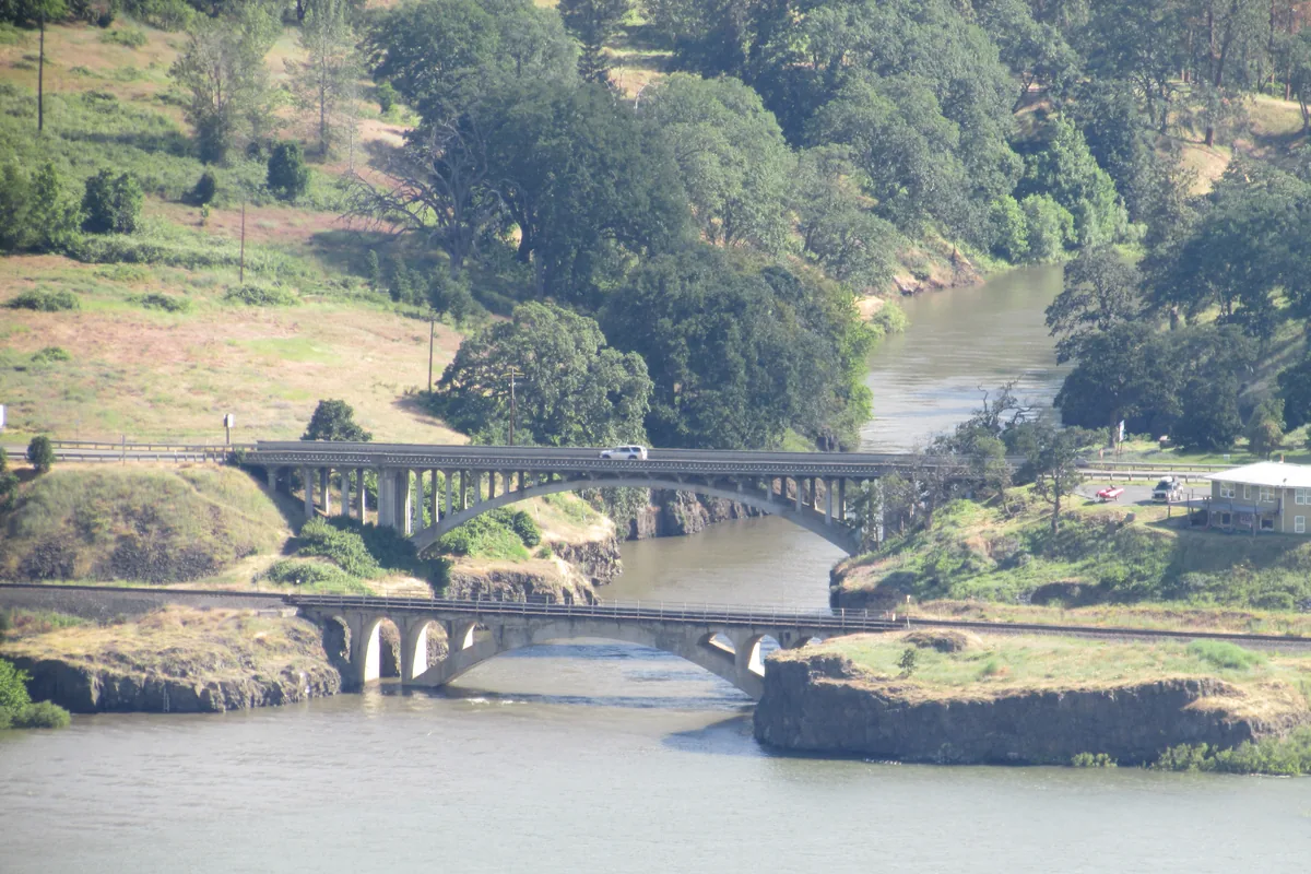 Wide view of the Klickitat River gorge with highway and railroad bridges crossing near its mouth on the Columbia River, Washington