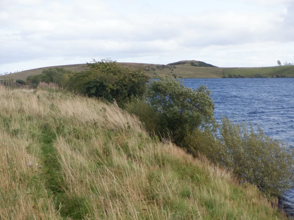 View across Loch Coulter Reservoir toward Skea Craig hill near Stirling, Scotland