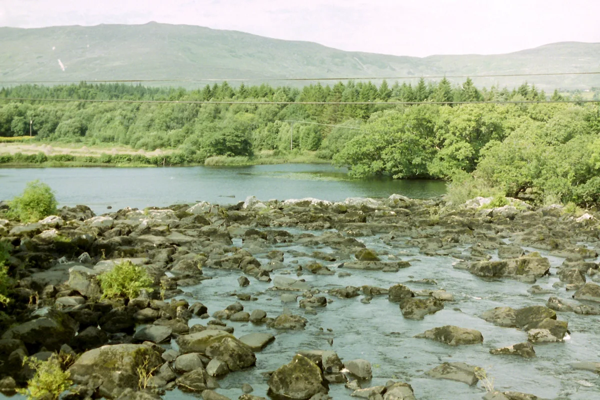 The Caragh River winding through a green valley on the Ring of Kerry, County Kerry, Ireland.