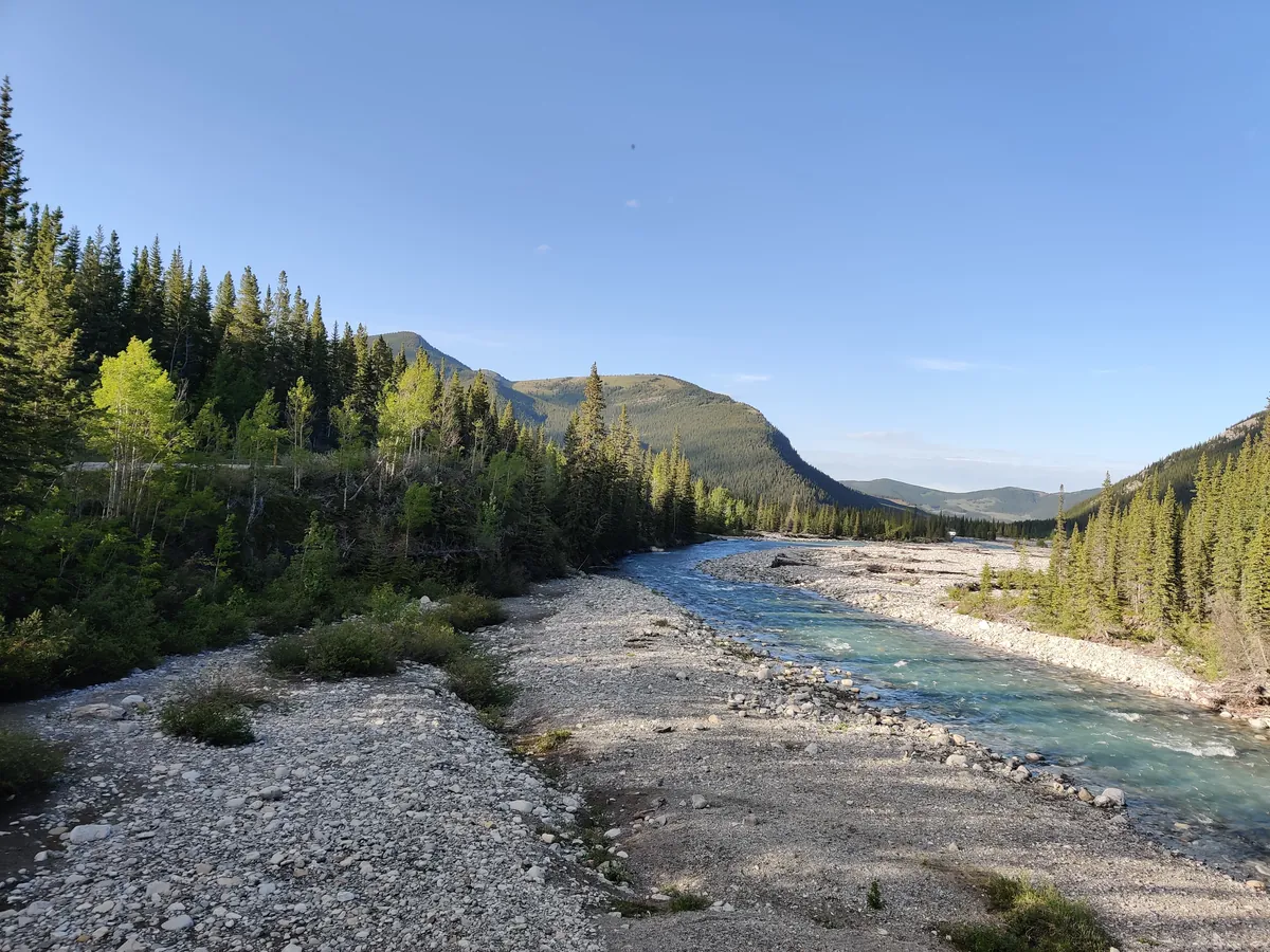 The turquoise glacial waters of the Elbow River flowing through Kananaskis Country, Alberta