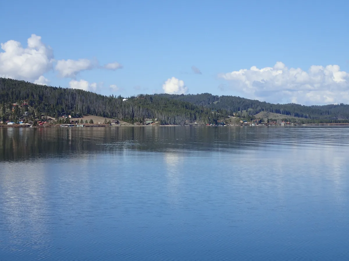 Wide calm view of Georgetown Lake with forested hills in the Pintler region of Montana