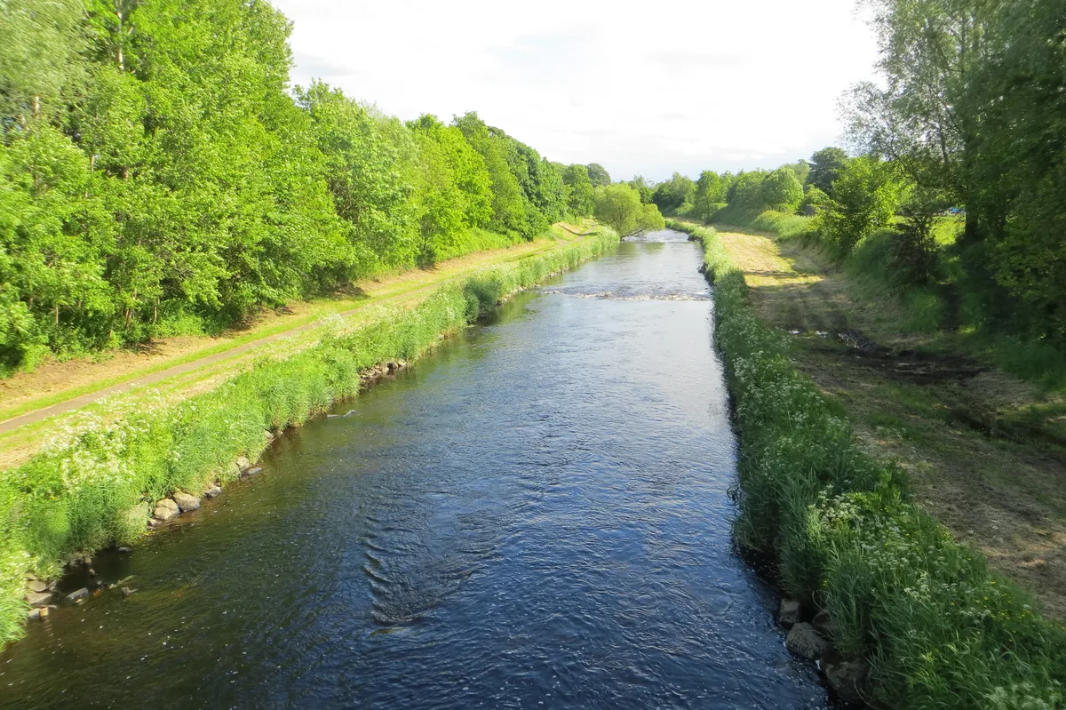 Wide view of the River Maine flowing through countryside near Ballymena, County Antrim, Northern Ireland.