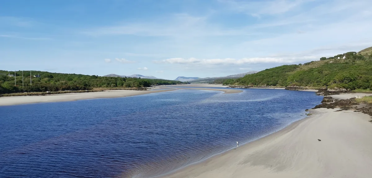 Wide view of the tidal Gweebarra River estuary with sandbars and hills in the distance, County Donegal, Ireland