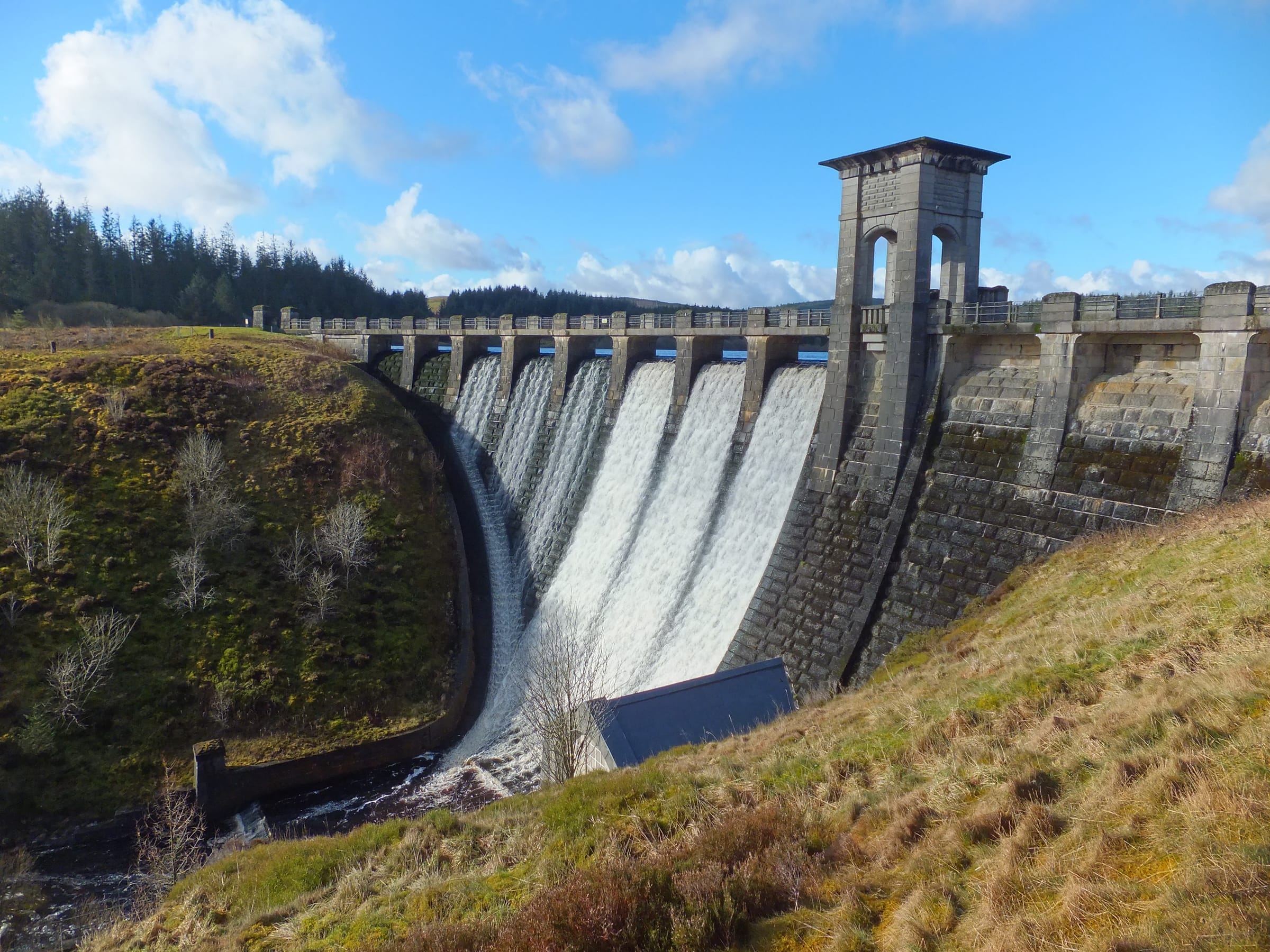 Alwen Reservoir dam during a spill event, water cascading over the overflow weir.