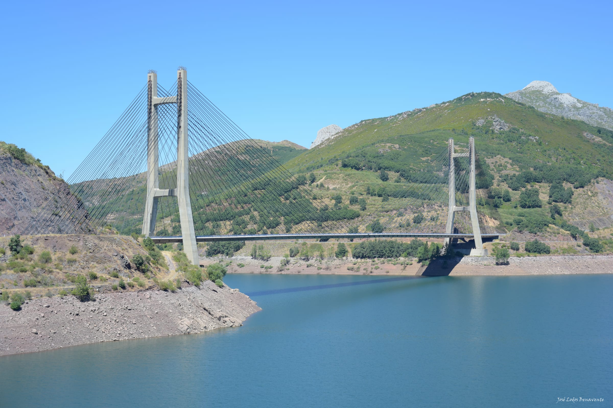 The Carlos Fernández Casado cable-stayed bridge over the blue-green waters of Barrios de Luna reservoir.