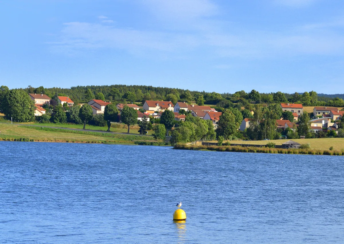 Lac de Naussac reservoir with lakeside village on the far shore, Margeride, Lozère, France