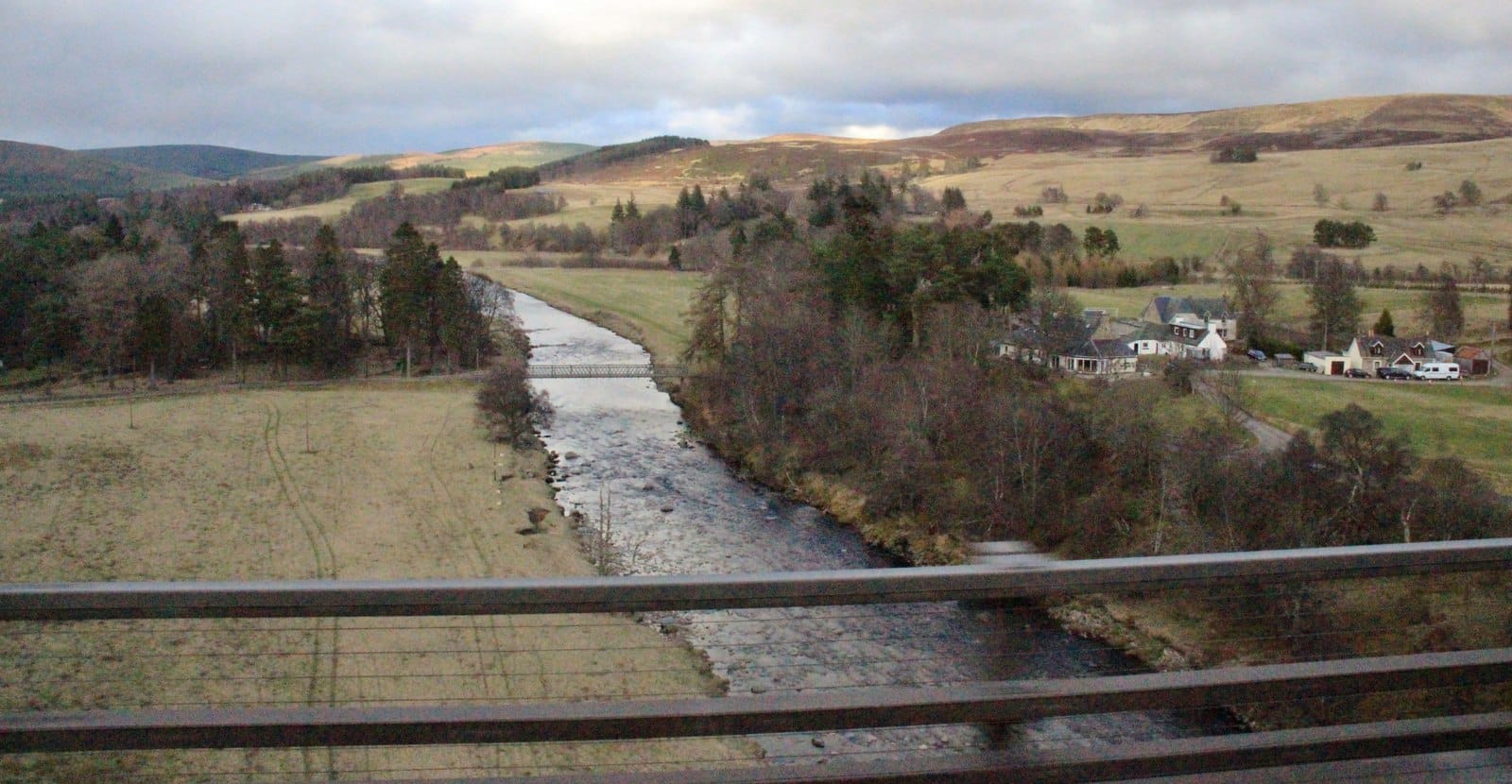 A wide view of the River Findhorn running through open moorland at Tomatin in the upper reaches.