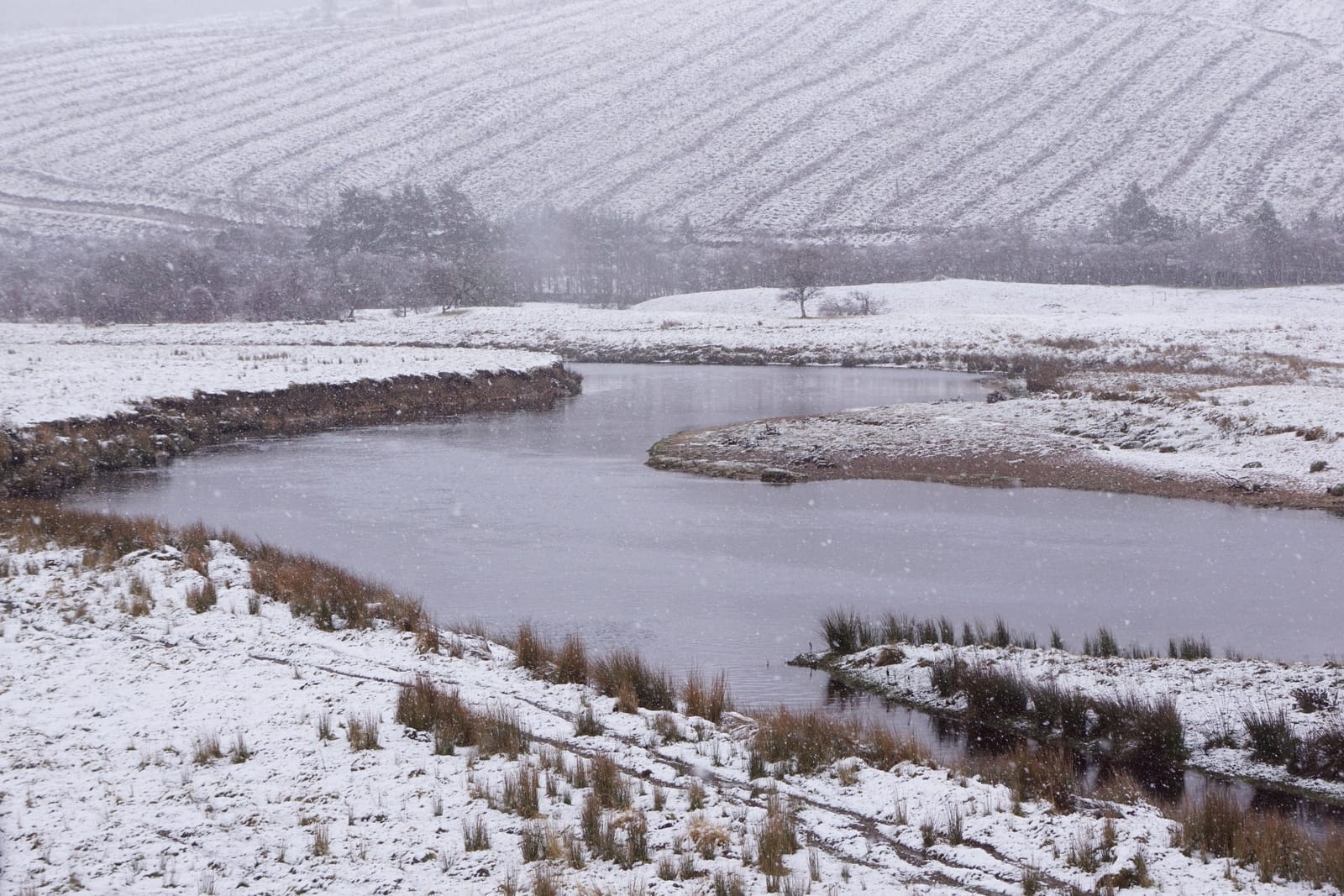The River Helmsdale at Balvalaich flowing through open Highland glen with heather moorland slopes either side.