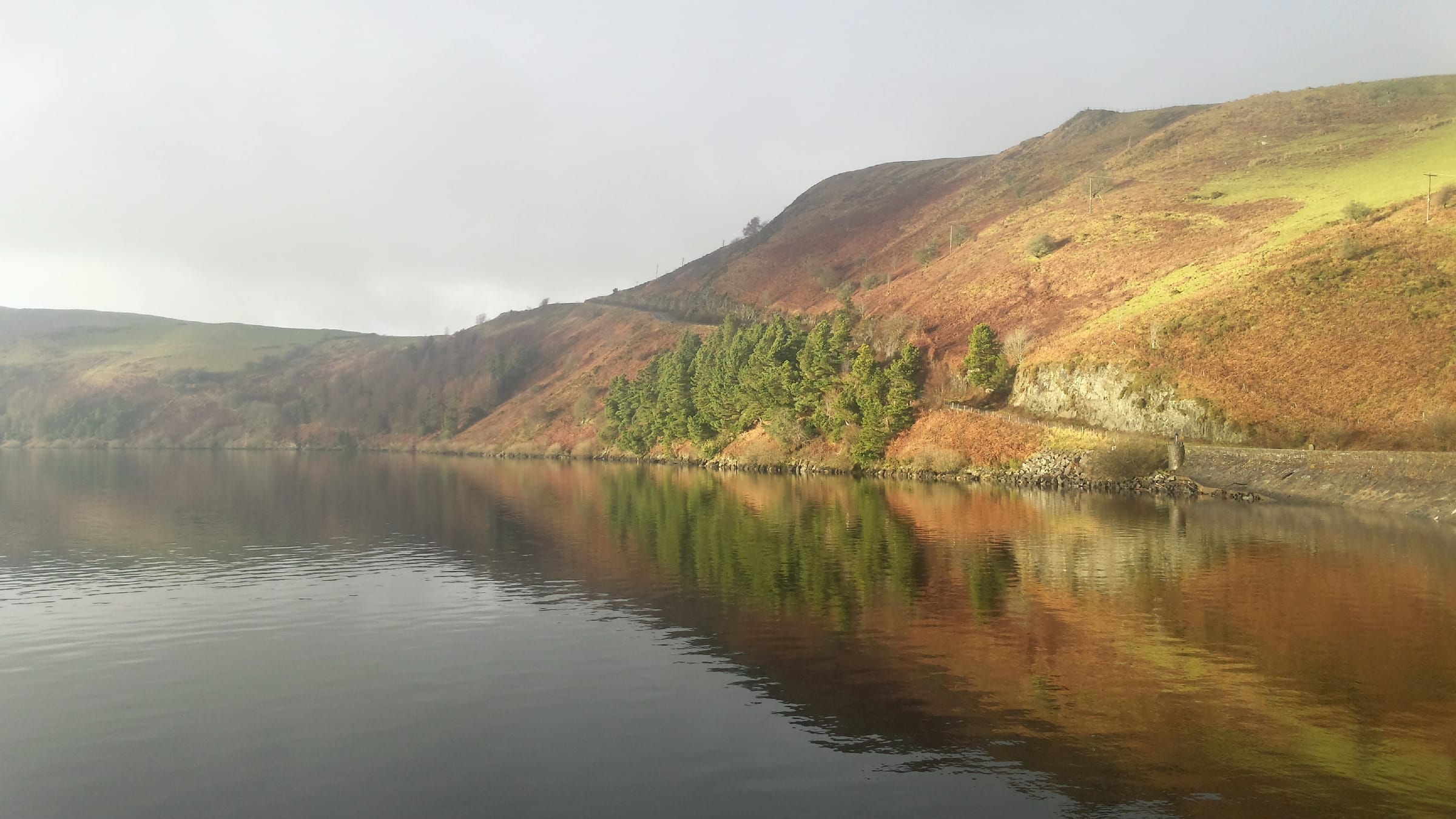 Wide view of Llyn Clywedog reservoir looking south across open water from the Bwlch-y-gle hillside.