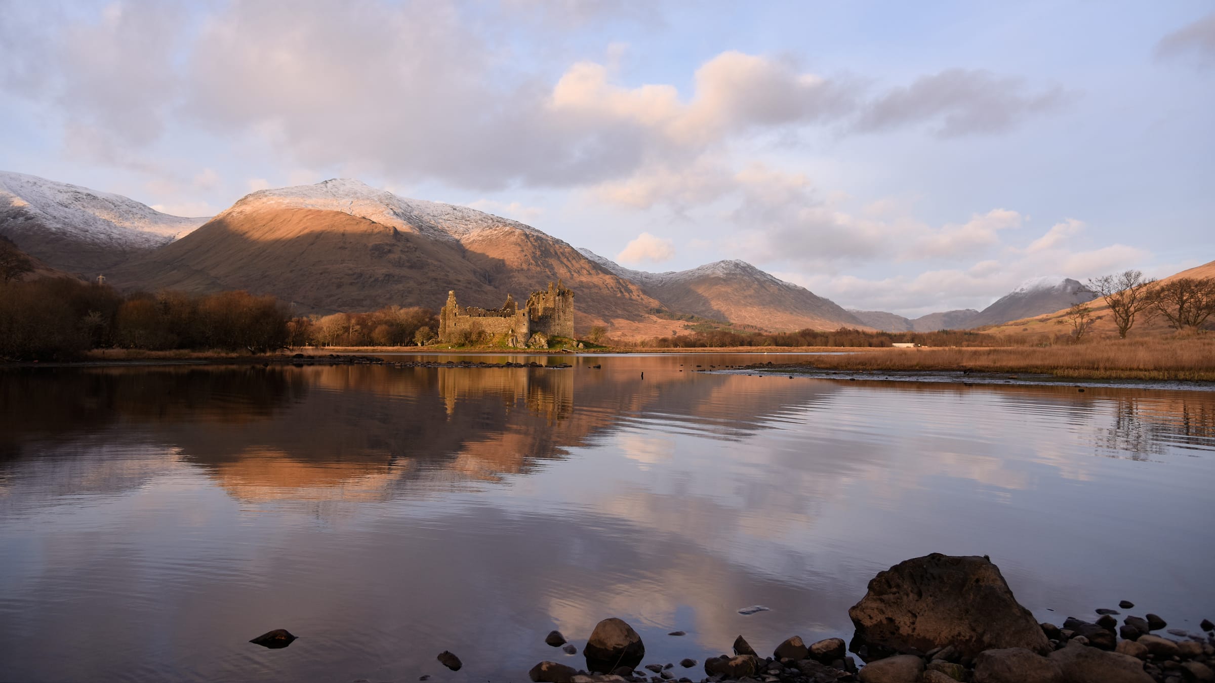 Loch Awe with Kilchurn Castle perfectly reflected in the still water, Scottish Highlands.