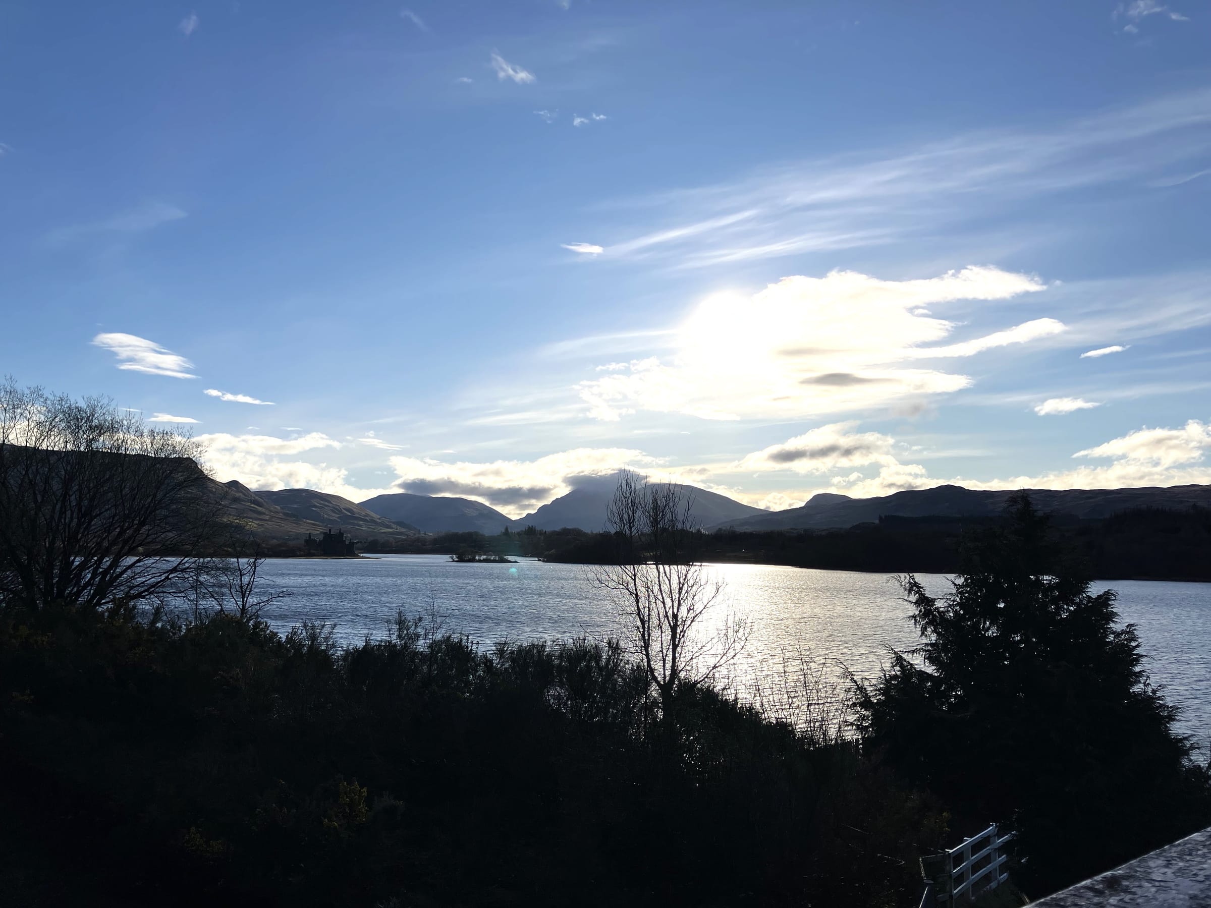 Sunrise over Loch Awe, Scotland, with golden light across the water.