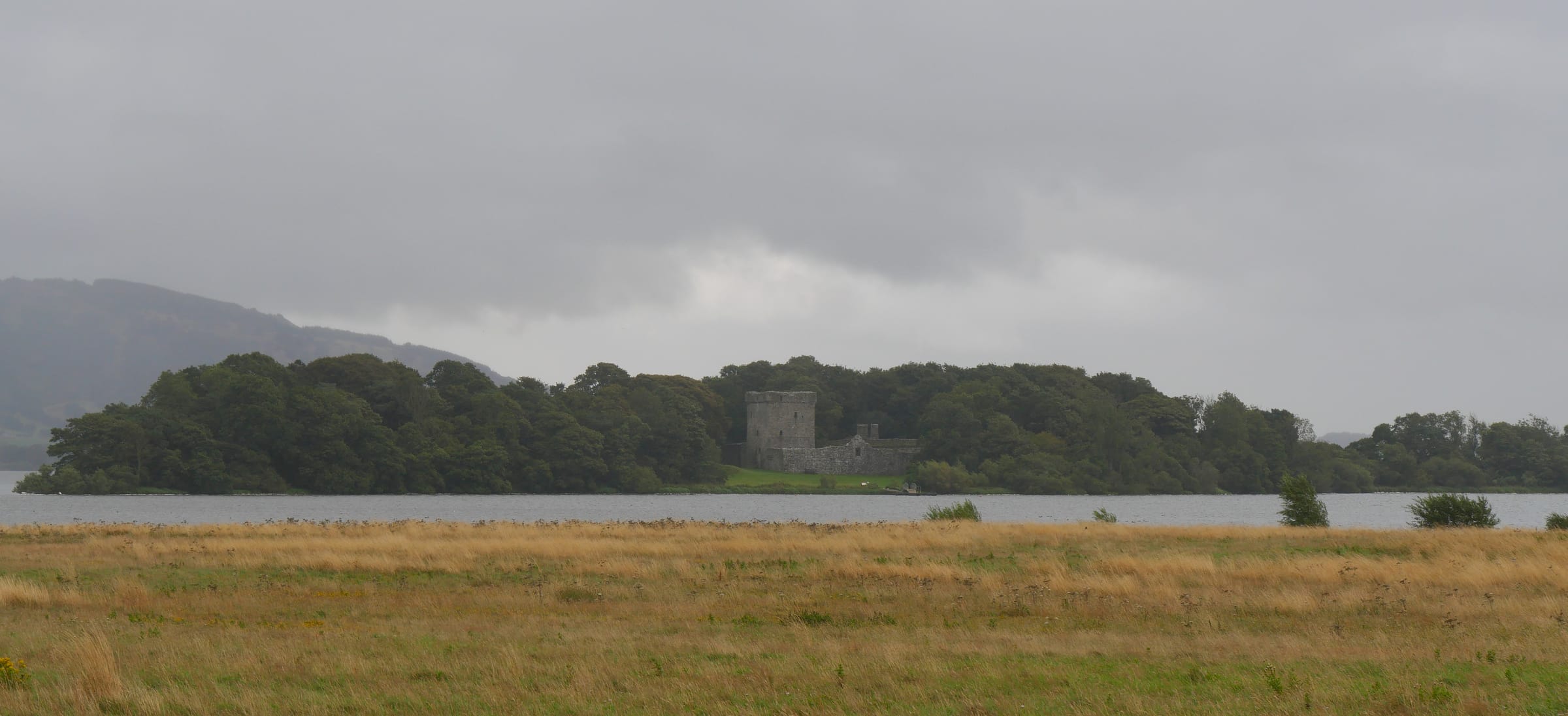 Panoramic view across the open water of Loch Leven toward Castle Island bearing Lochleven Castle, Kinross.