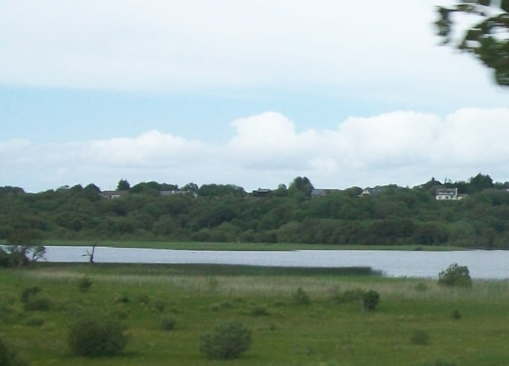 The western end of Lough Melvin near Kinlough, open lough water with meadows and Garrison across the water.