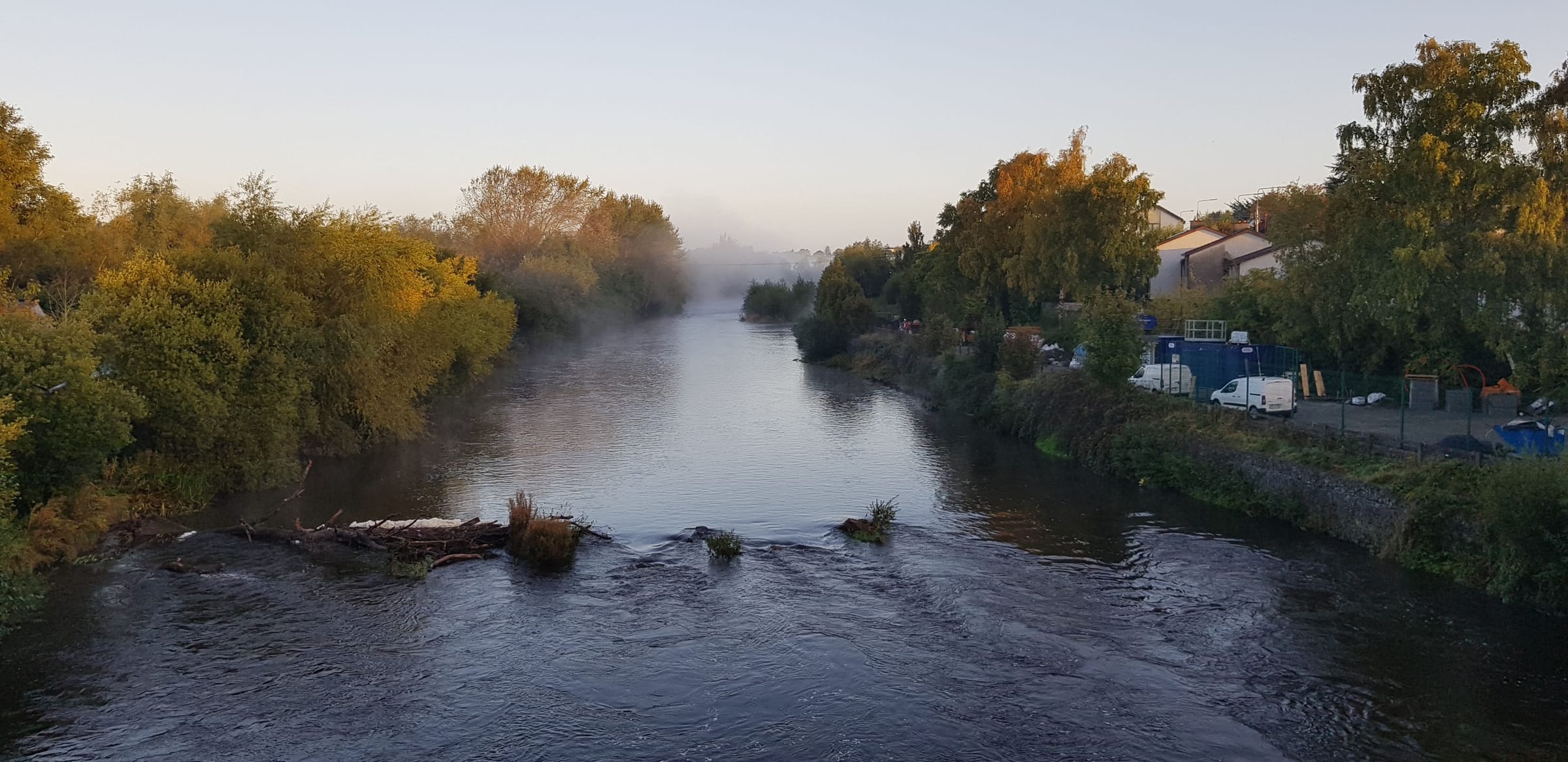 The River Nore drifting through Kilkenny town in early morning fog.