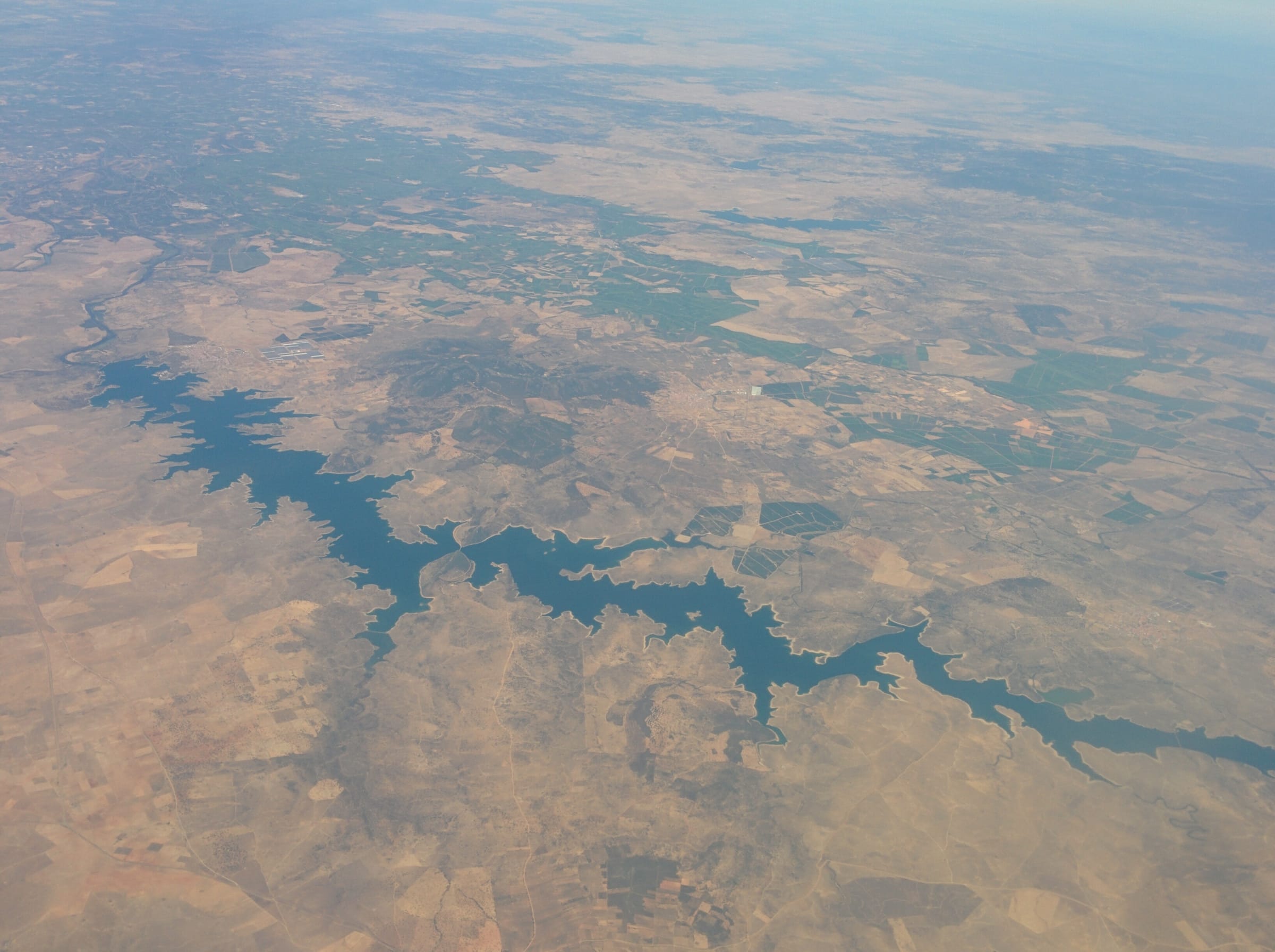 Aerial view over the broad open surface of Embalse de Orellana, Badajoz, Extremadura.