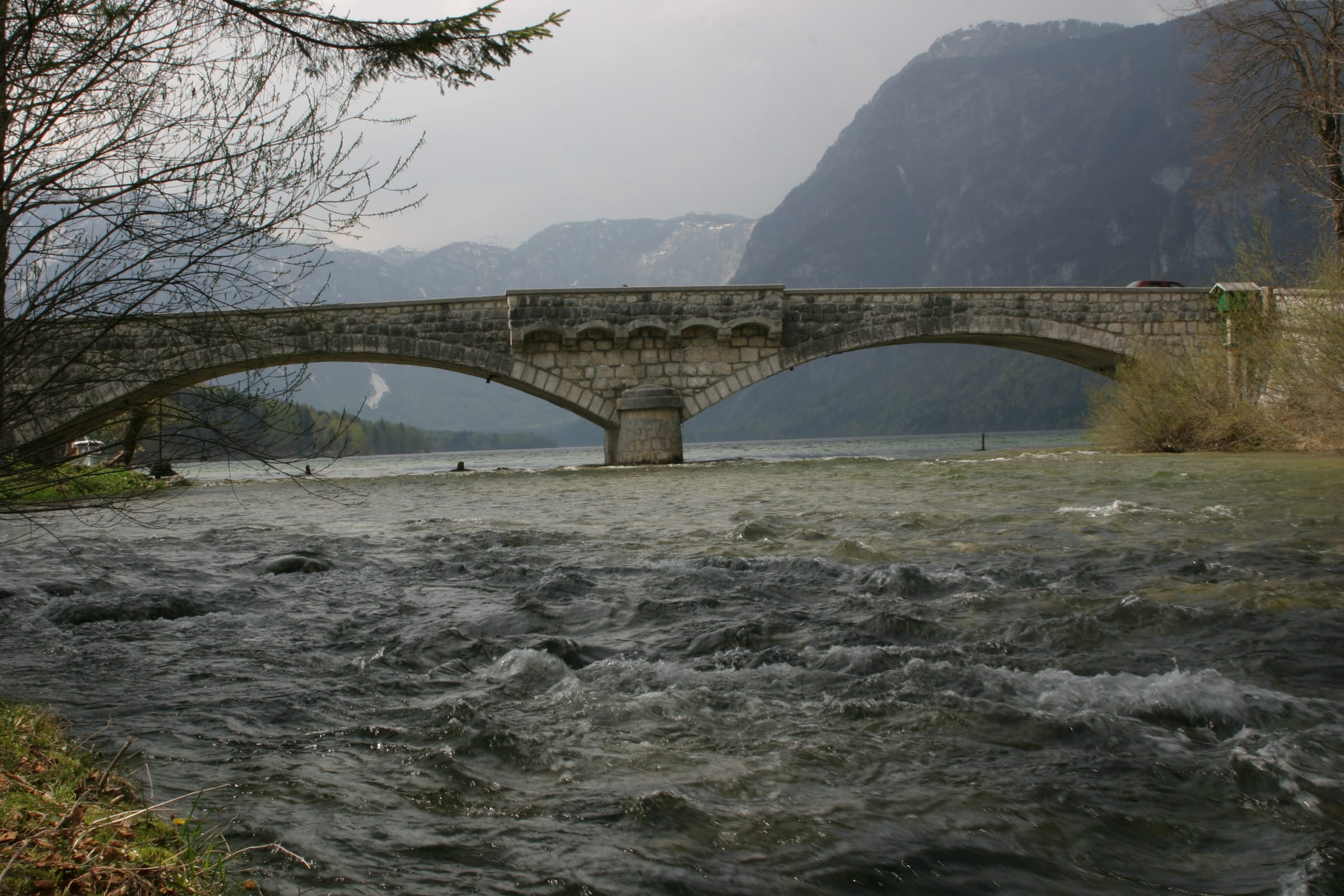 The Sava Bohinjka outflow from Lake Bohinj at Ribčev Laz, clear water between rocky banks.