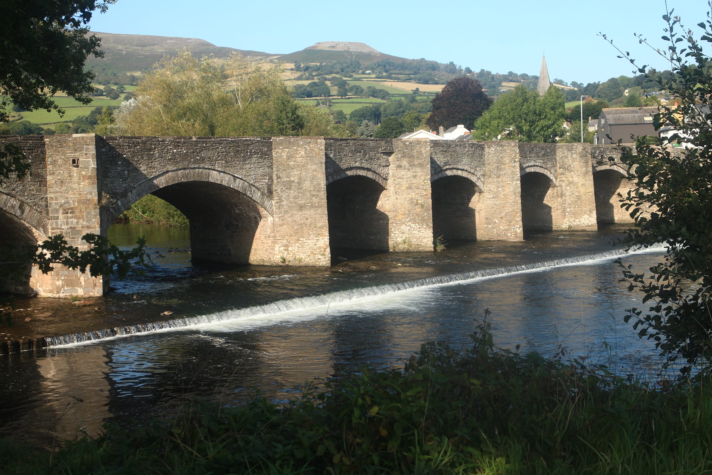 The River Usk flowing through the valley below the flat-topped summit of Table Mountain (Crug Hywel) at Crickhowell.