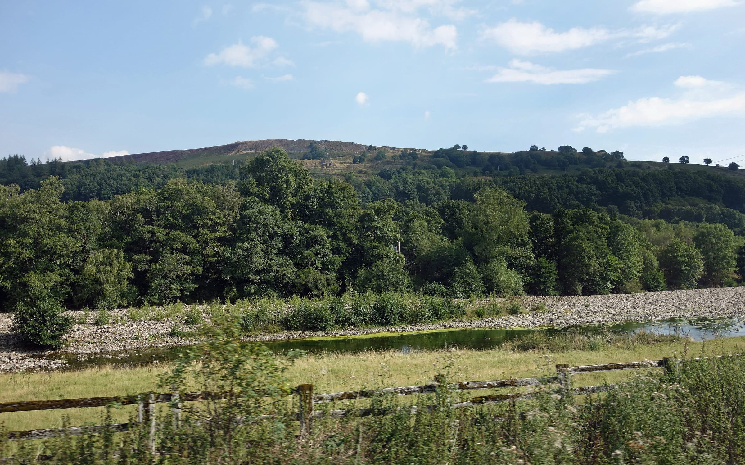 The River Wear sweeping through a broad meander downstream of Stanhope in low summer water.